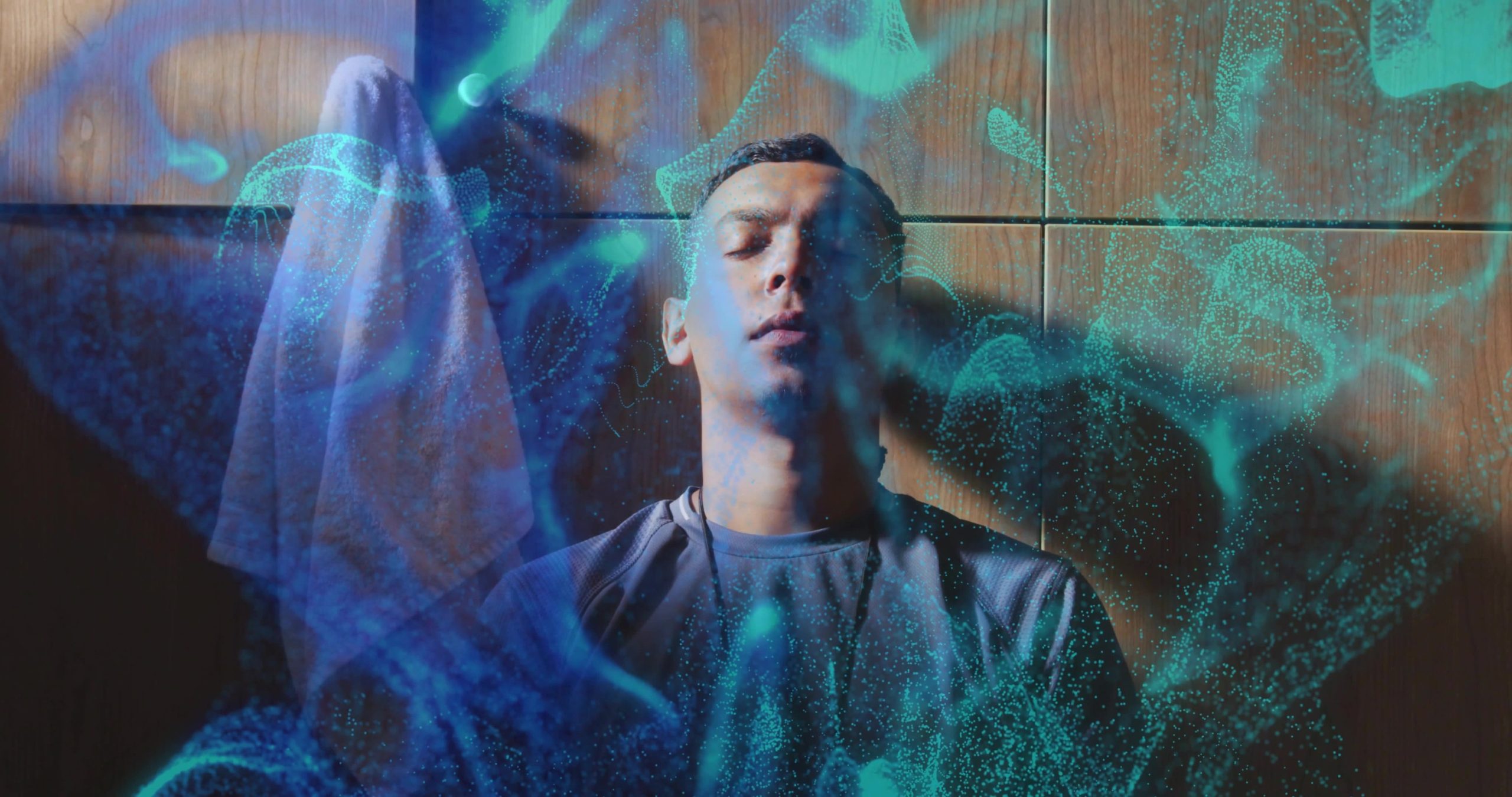 A person sits against a wooden wall with eyes closed, surrounded by swirling blue and teal abstract shapes, evoking a dreamlike or meditative atmosphere that suggests the calm found through trauma healing.